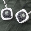 Two digital temperature controllers on a textured dark surface
