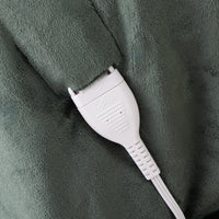 White cord connector on a green textured surface