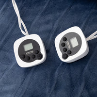Two digital temperature controllers on a textured blue surface