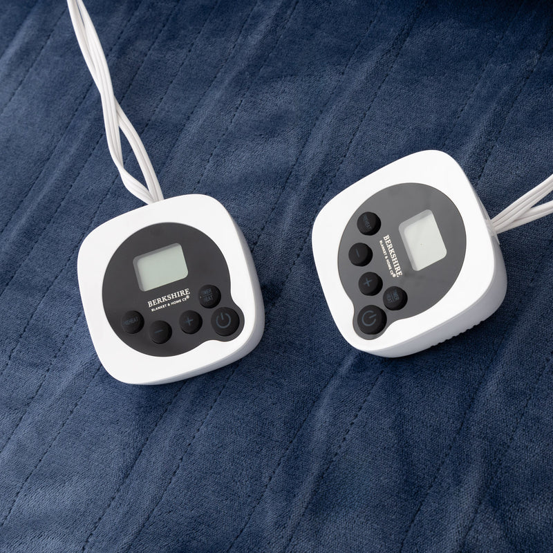 Two digital temperature controllers on a textured blue surface