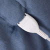 White electrical plug on a blue textured surface