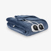 Folded electric blanket with control panels on a white background