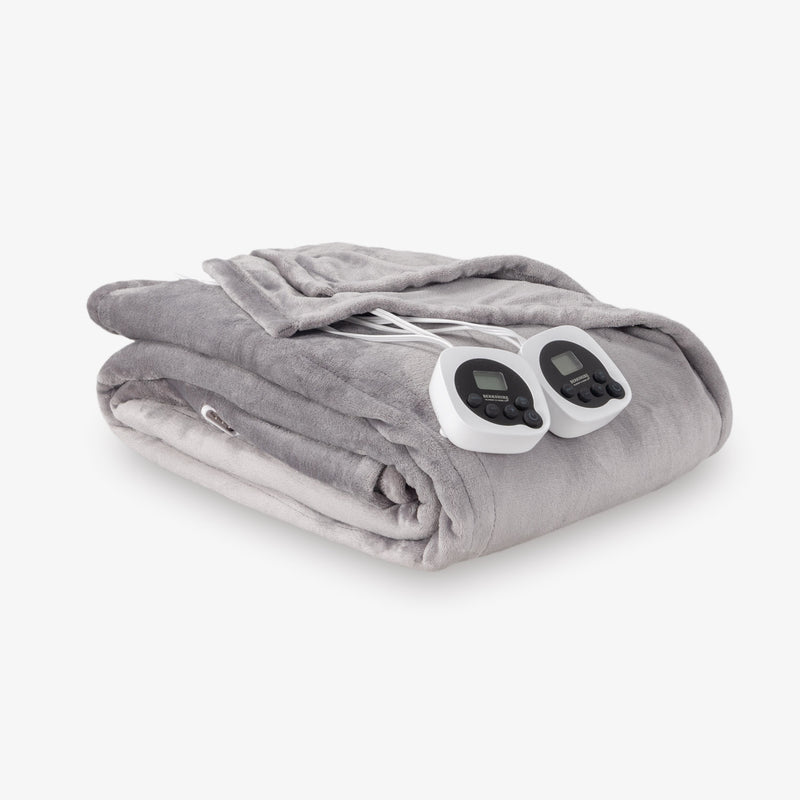 Gray electric blanket with two controllers on a white background