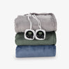 Stack of folded heated blankets with electric cords on a white background