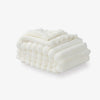 A white faux fur throw on a white background