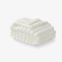 A white faux fur throw on a white background