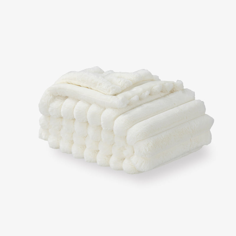 A white faux fur throw on a white background