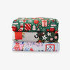 Stack of three colorful fabric swatches with festive patterns on a white background