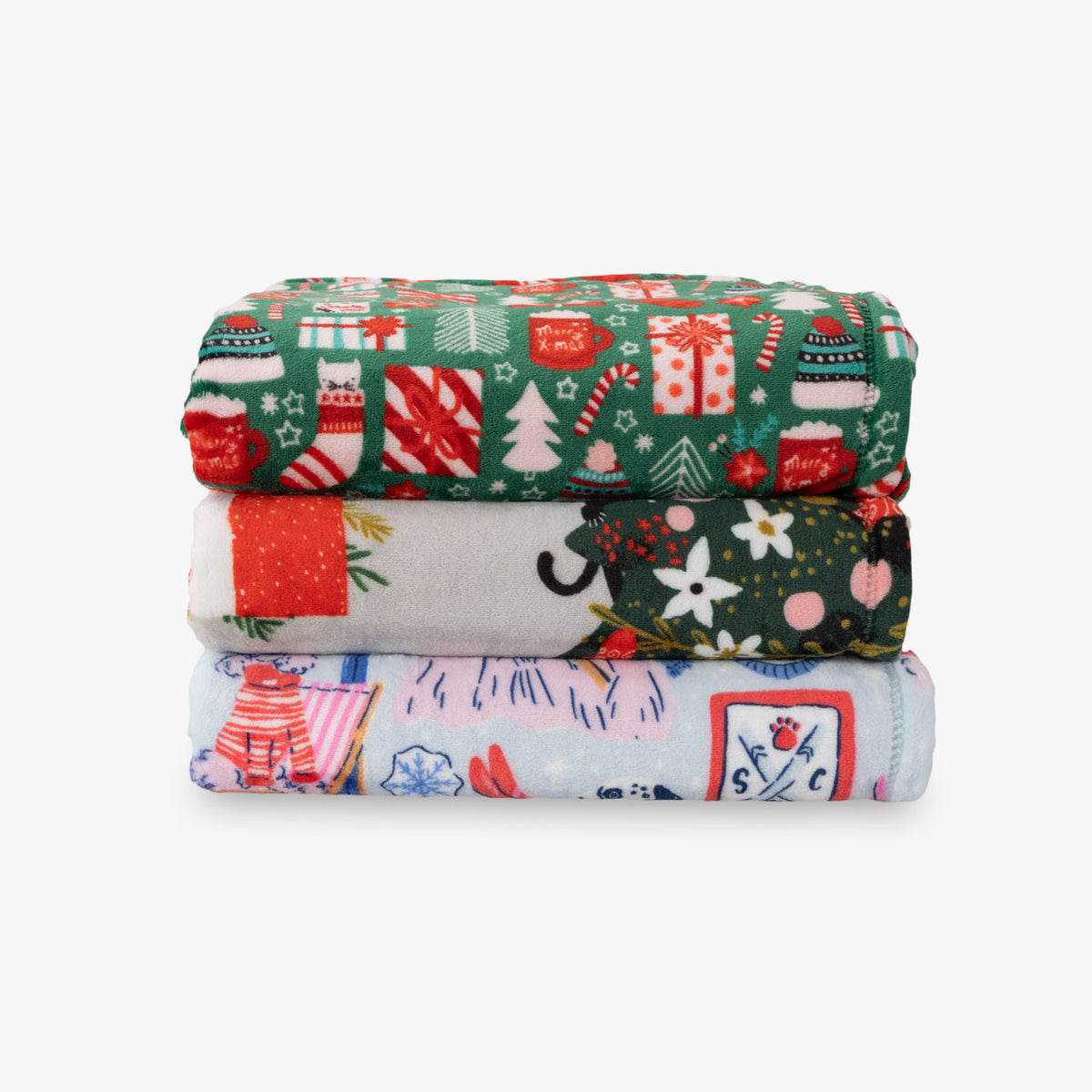 Stack of three colorful fabric swatches with festive patterns on a white background