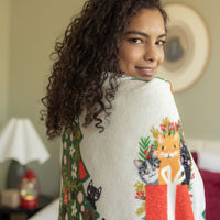 Cat printed holiday throw draped over a womans shoulders.