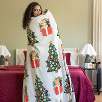 Cat printed holiday throw draped over a womans shoulders.