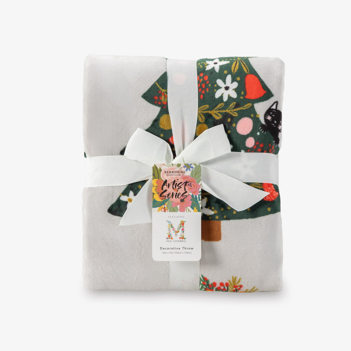 Decorative throw blanket with festive design and brand label on a white background