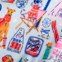 Colorful pattern with skiers, dogs, and skiing equipment on a white background