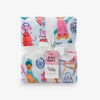 Folded decorative throw blanket with colorful dog illustrations and a white ribbon on a white background.