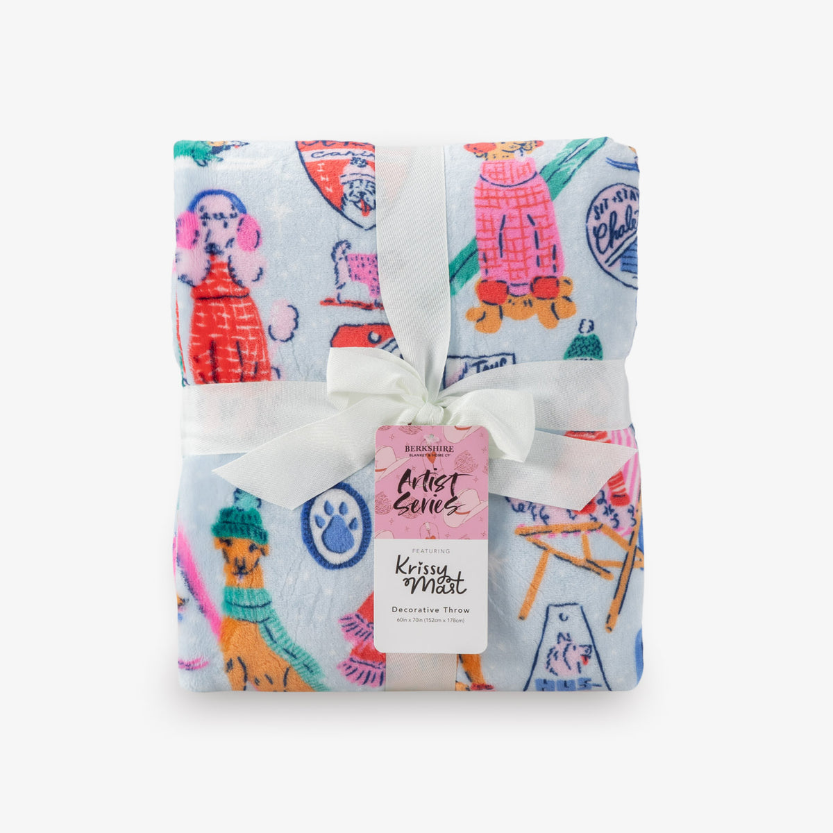 Folded decorative throw blanket with colorful dog illustrations and a white ribbon on a white background.