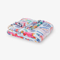 Colorful quilt with cartoon character pattern on a white background