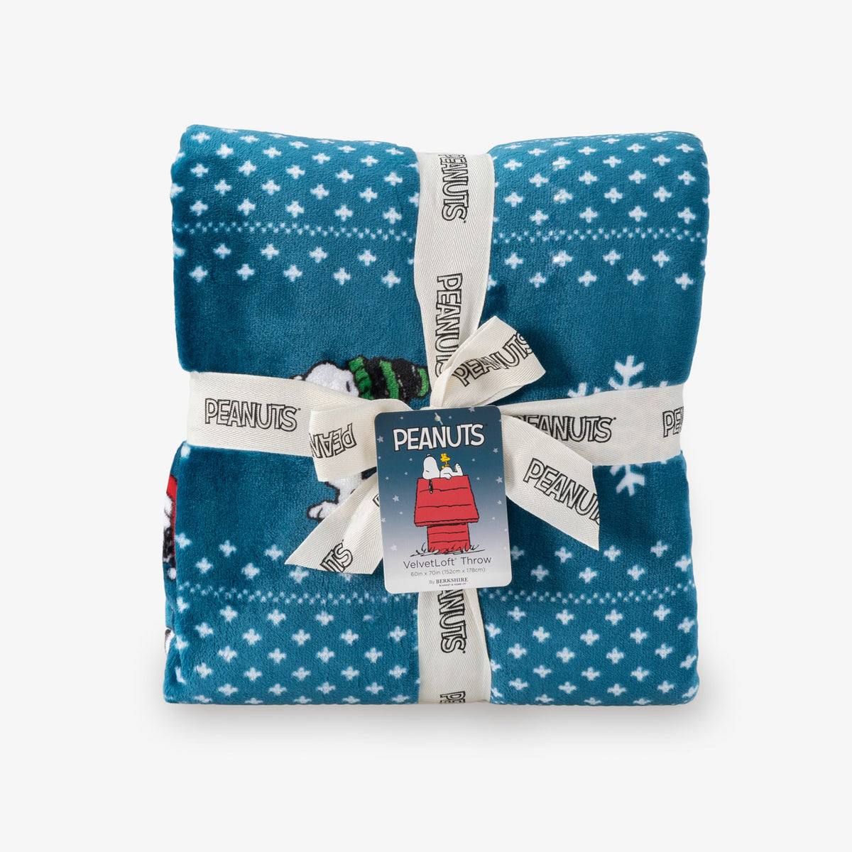 Folded blue blanket with white star pattern, wrapped in Peanuts-themed gift wrap on a white background