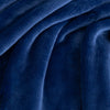 A close up of a blue velvety plush throw displaying its silky smooth texture.