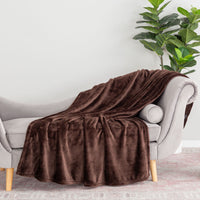 A brown velvety plush throw draped neatly over the arm of a grey chair.