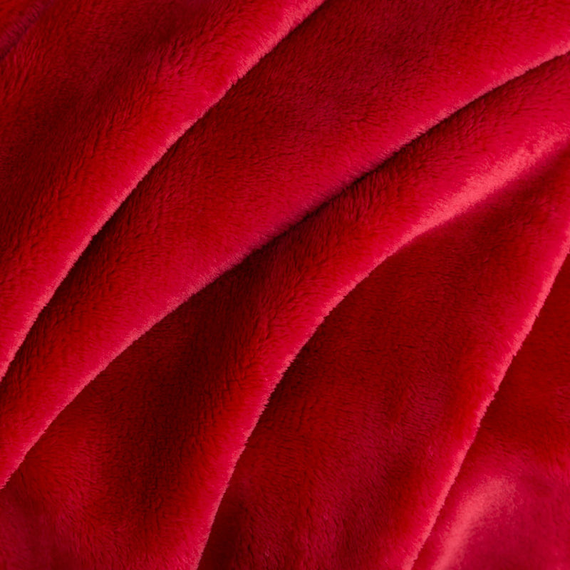 Close up of a neon red velvety throw displaying its smooth and plush texture.