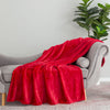 A neon red velvety throw draped neatly over a grey chair.