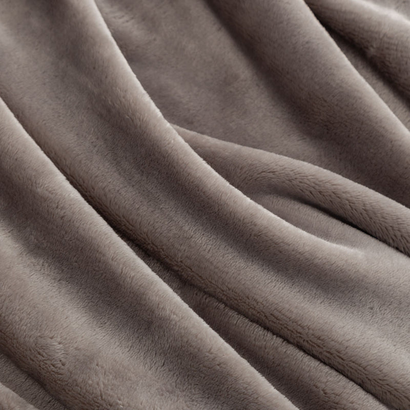 Close up of a grey velvety plush throw displaying its silky plush texture.