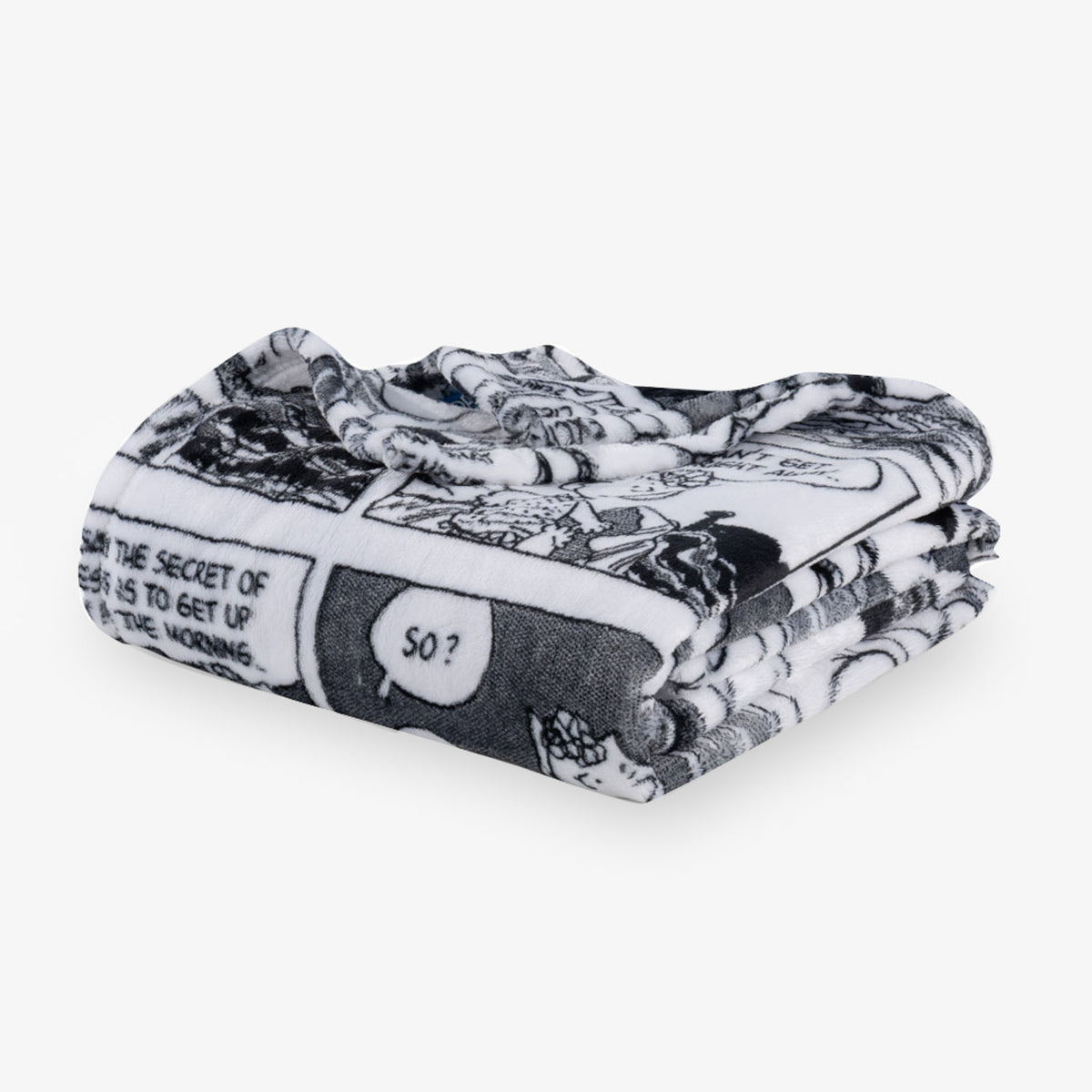 Folded black and white patterned blanket on a white background