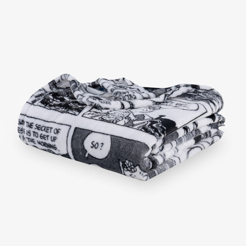 Folded black and white patterned blanket on a white background