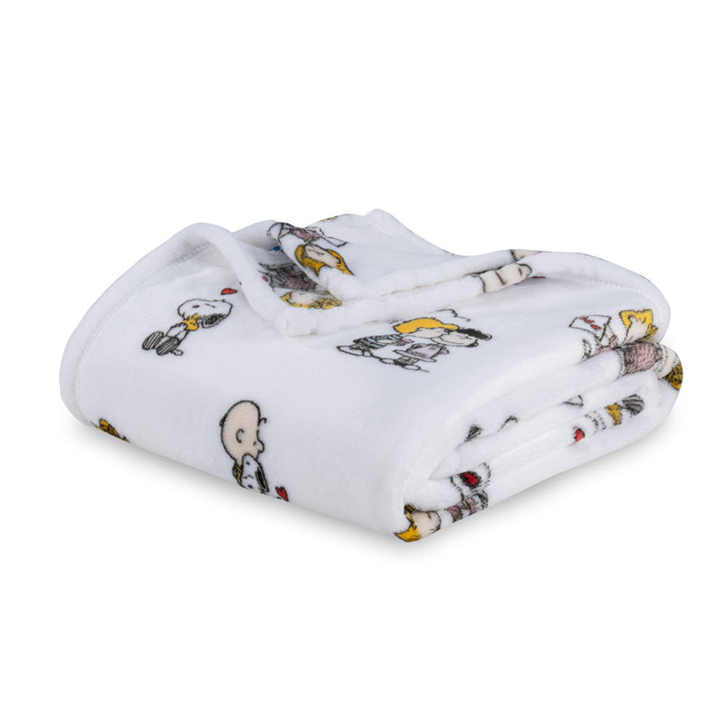 White peanuts valentines day throw folded neatly on a white surface.