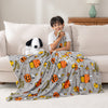 Halloween peanuts throw draped over a kids lap.