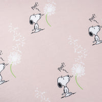 Close up of a pink Peanuts make a wish throw, displaying the print and silky smooth texture.