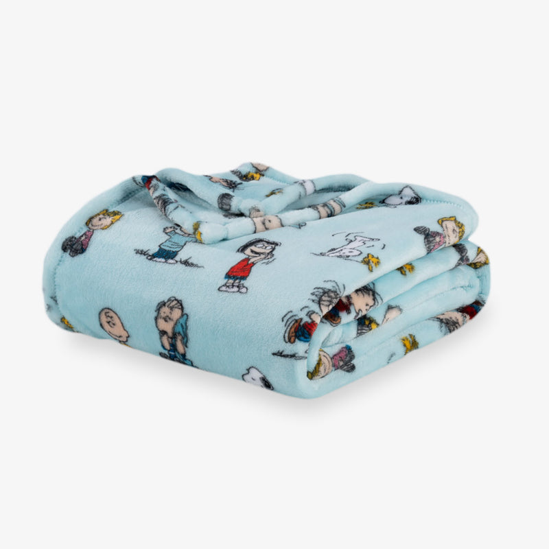 Folded blanket with cartoon character pattern on a light blue background