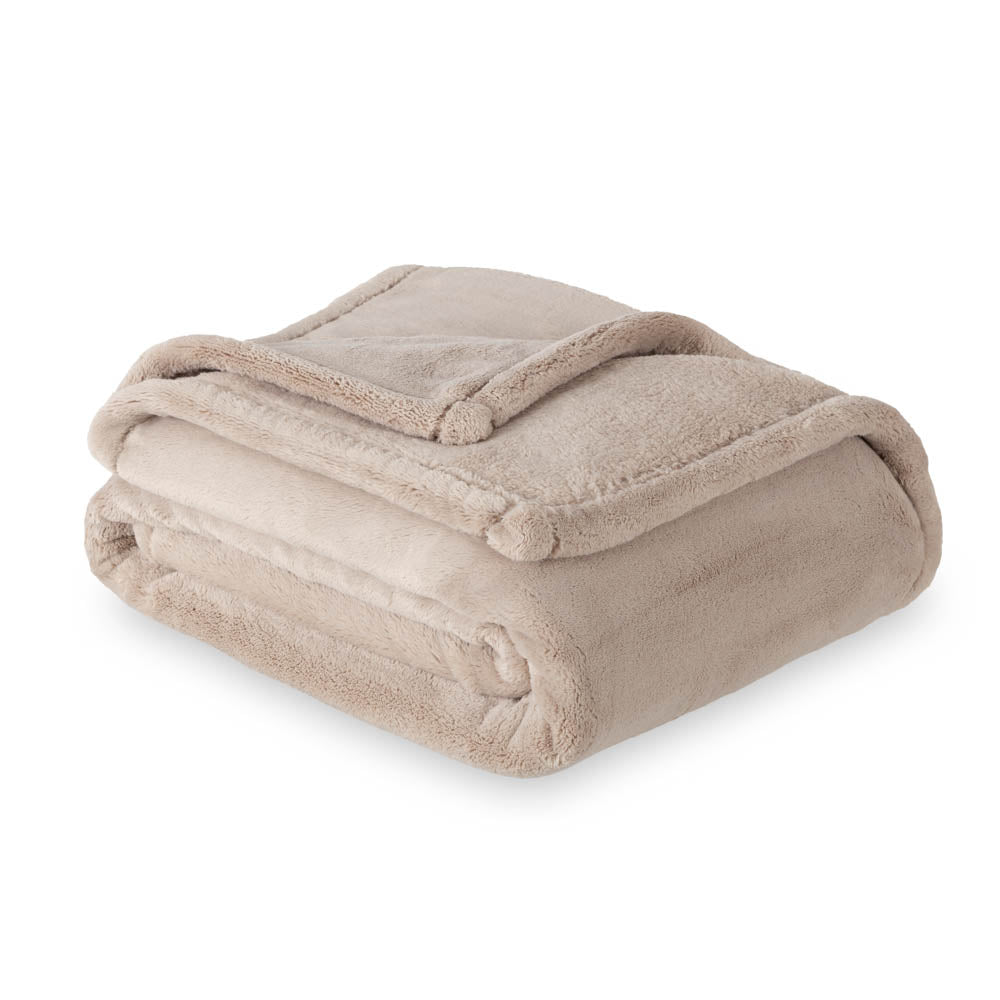 A beige PrimaLush Throw folded neatly on a white surface.