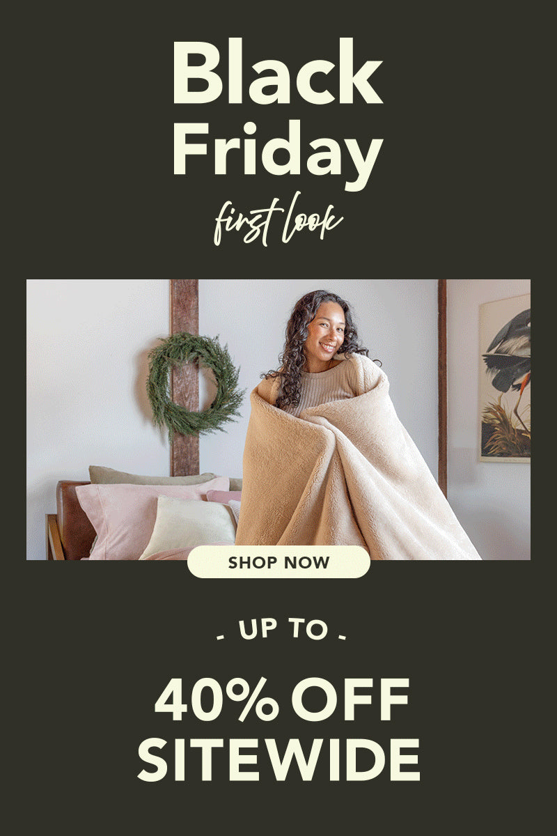 Black Friday First Look Shop Now Up to 40% OFF. Woman wrapped in blanket