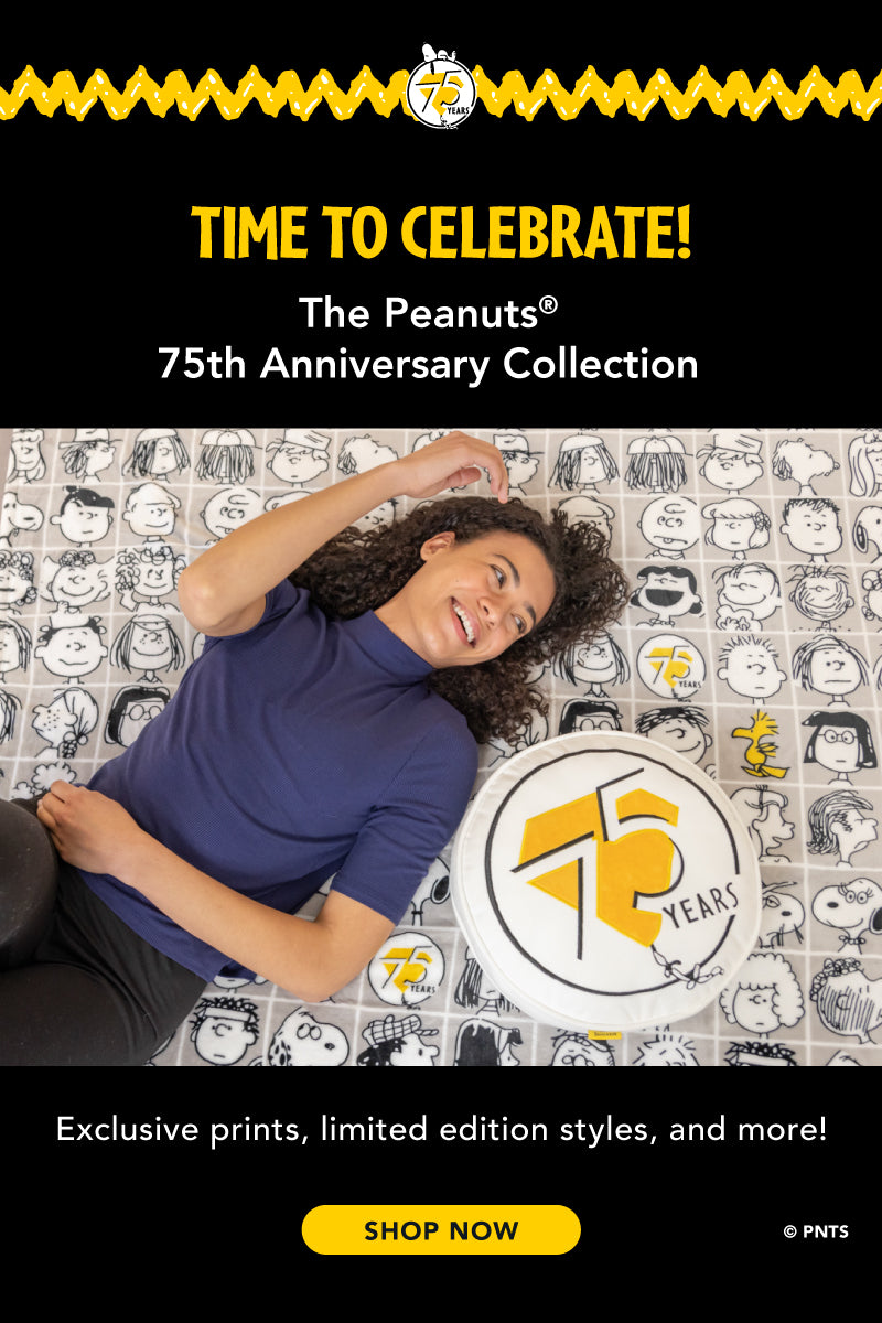 Time to Celebrate! The Peanuts® 75th Anniversary. Exclusive prints, limited edition styles, and more! Shop now. Image of a woman laying on her bed with the throw and pillow anniversary set.