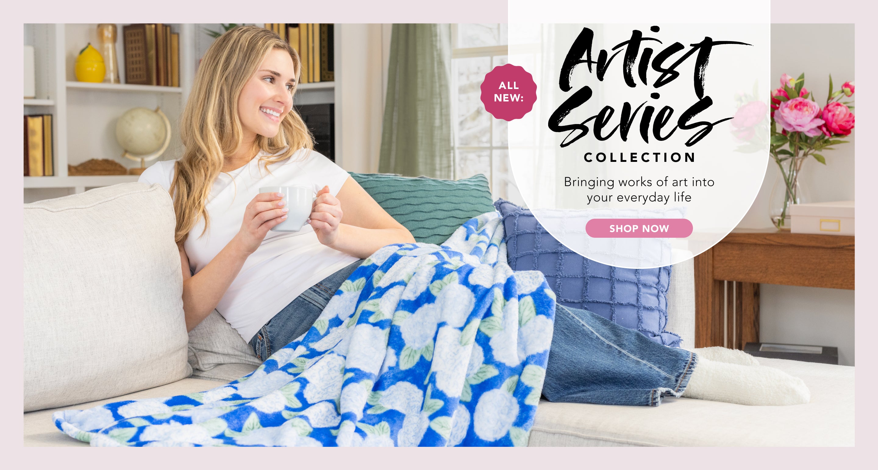 ALL NEW: Artist Series Collection. Bringing works of art into your everyday life. Shop now. Image of a woman on the couch with a throw featuring a blue and white hydrangea floral design.