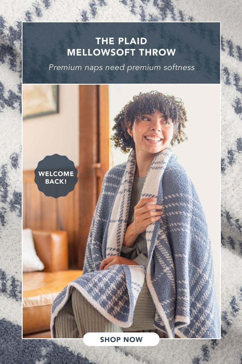 Welcome Back! The plaid MellowSoft throw. premium naps need premium softness. Shop now. Image of a girl enjoying a blue and white plaid throw in a living room.