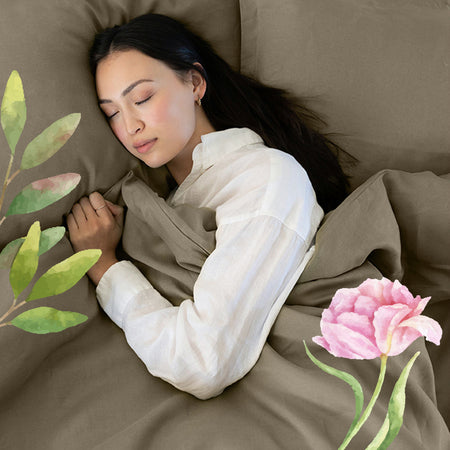 Spring collection cover image featuring a woman sleeping underneath our green Organic Linen Sheets Duvet Set with flower clip art around her.