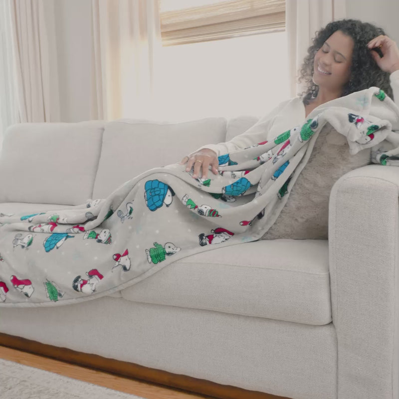 Video with a model and our Peanuts VelvetLoft Holiday Throw.